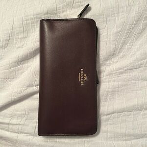 Coach burgandy smooth leather wallet. Good condition outside. Wear on inside